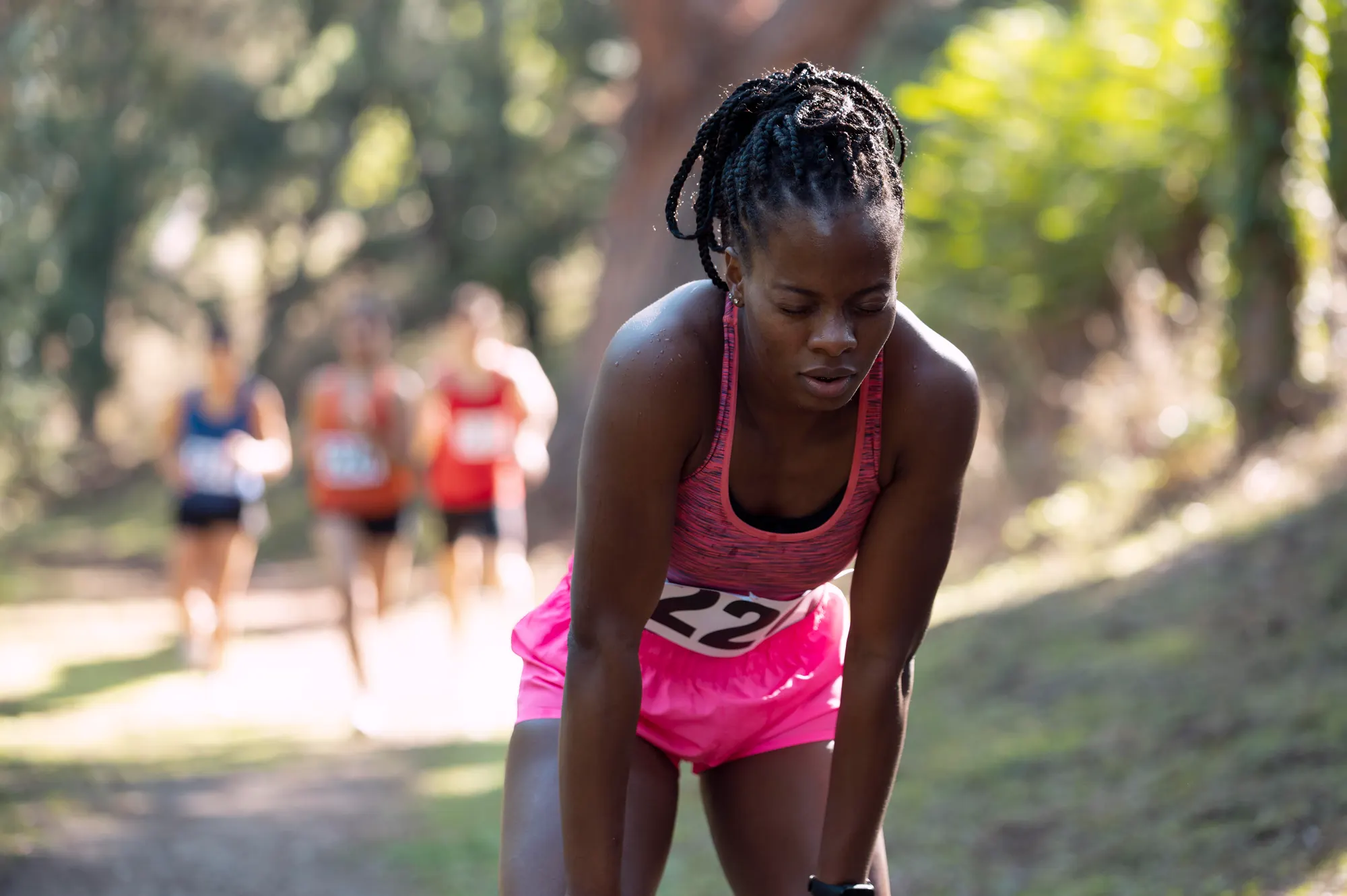 A runner catching her breath during a cross-country race
